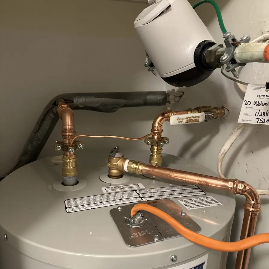 Top of a newly installed water heater with fresh copper supply lines