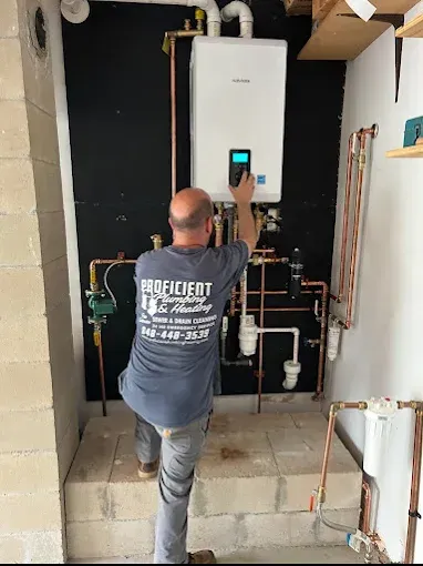 Proficient Plumbing & Heating technician programming a new tankless water heater